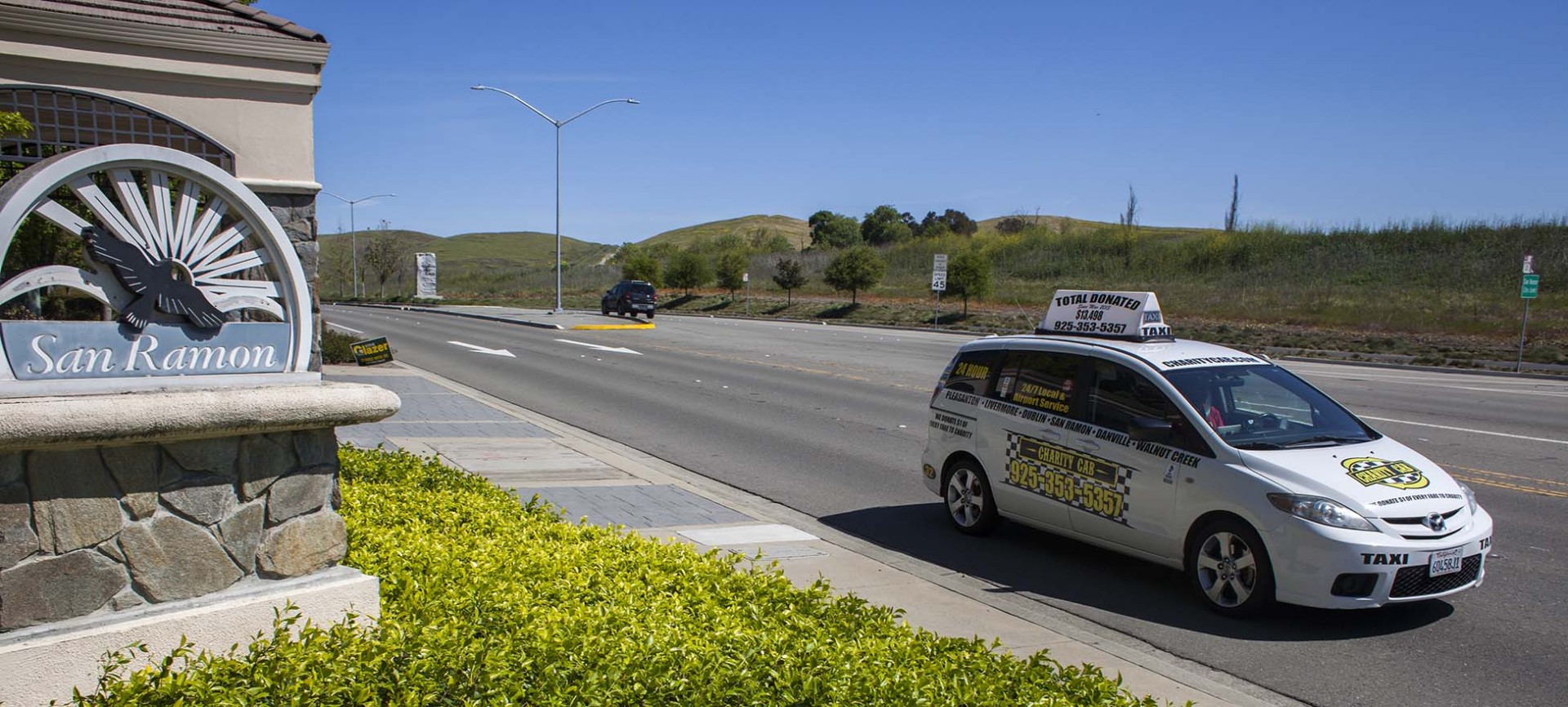 Charity Cab taxi drives by San Ramon city sign